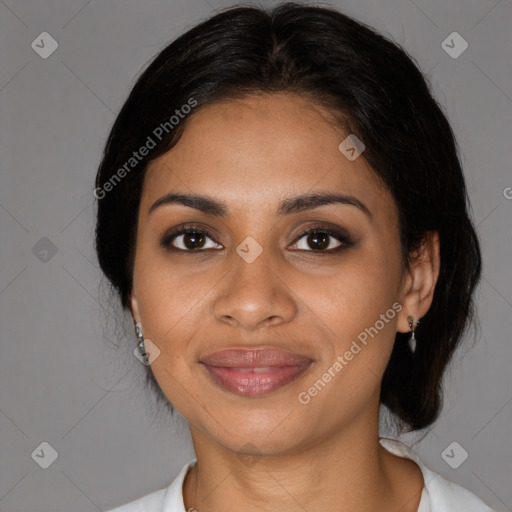 Joyful black young-adult female with medium  black hair and brown eyes