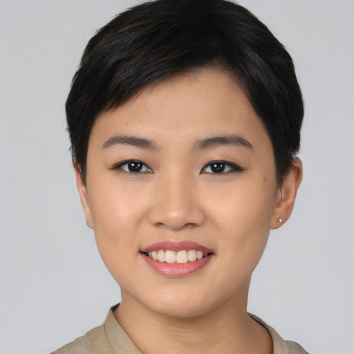 Joyful asian young-adult female with short  black hair and brown eyes