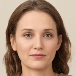 Joyful white young-adult female with medium  brown hair and green eyes