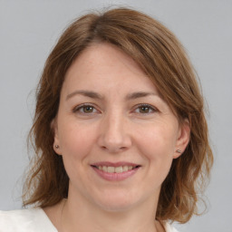 Joyful white adult female with medium  brown hair and brown eyes