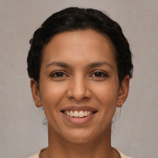 Joyful latino young-adult female with short  brown hair and brown eyes