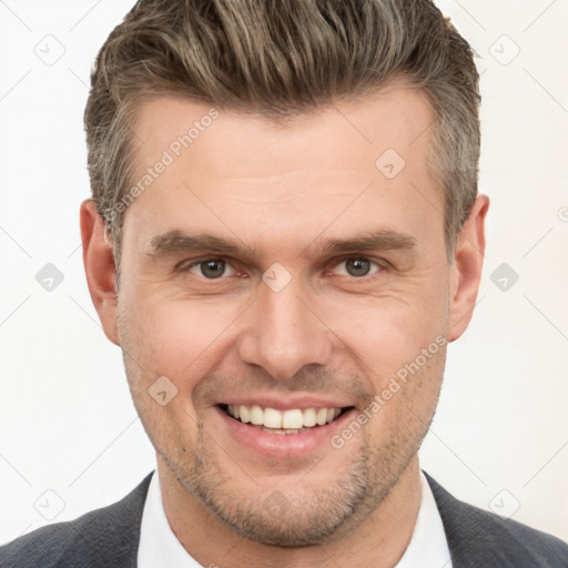 Joyful white adult male with short  brown hair and brown eyes