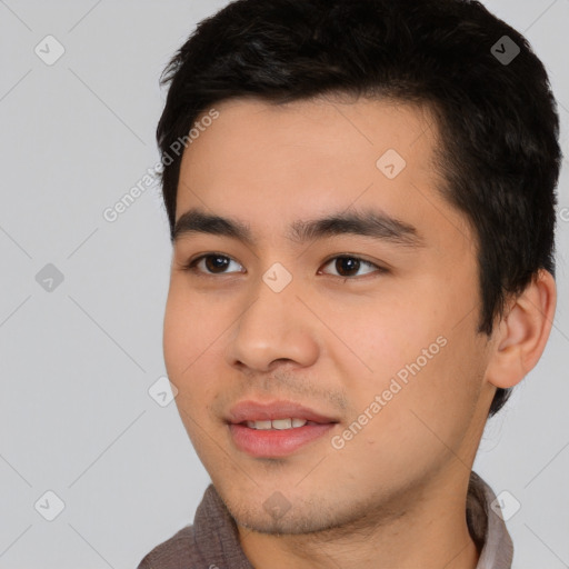 Joyful asian young-adult male with short  black hair and brown eyes