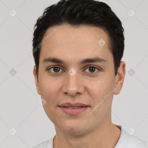 Joyful white young-adult male with short  black hair and brown eyes