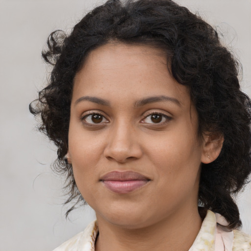 Joyful black young-adult female with medium  brown hair and brown eyes