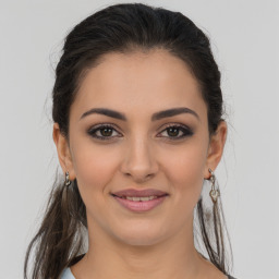 Joyful latino young-adult female with long  brown hair and brown eyes