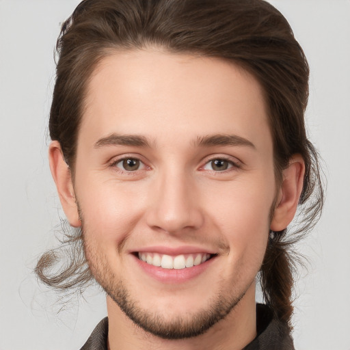 Joyful white young-adult male with medium  brown hair and brown eyes