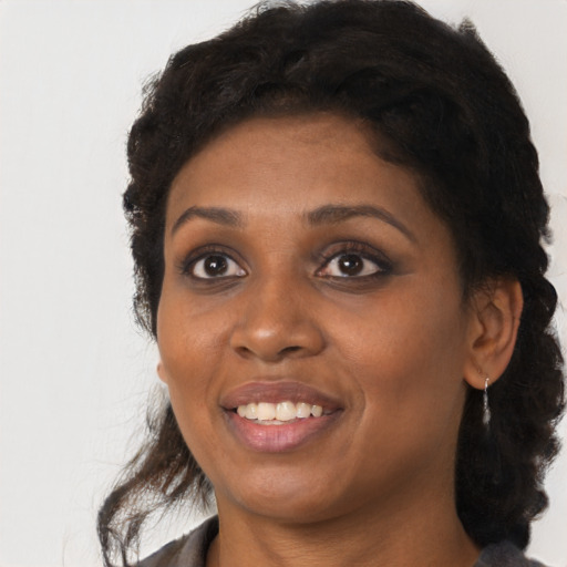 Joyful black young-adult female with medium  black hair and brown eyes