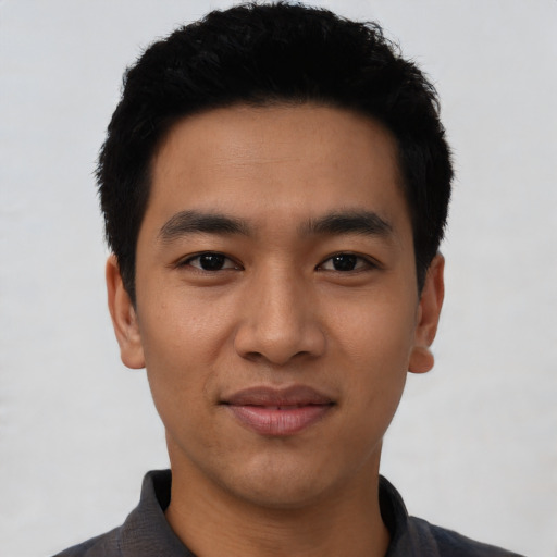 Joyful asian young-adult male with short  black hair and brown eyes