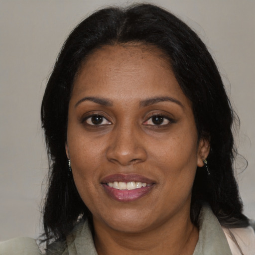 Joyful black adult female with medium  brown hair and brown eyes