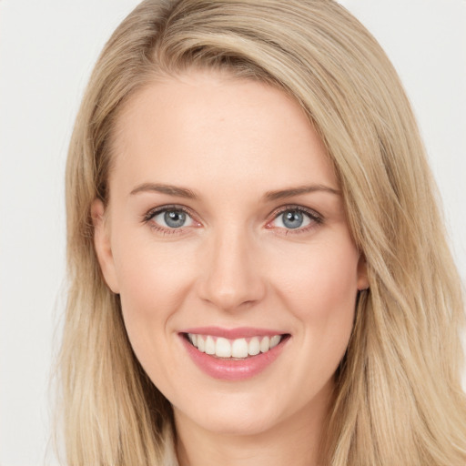 Joyful white young-adult female with long  brown hair and blue eyes