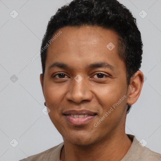 Joyful black young-adult male with short  black hair and brown eyes