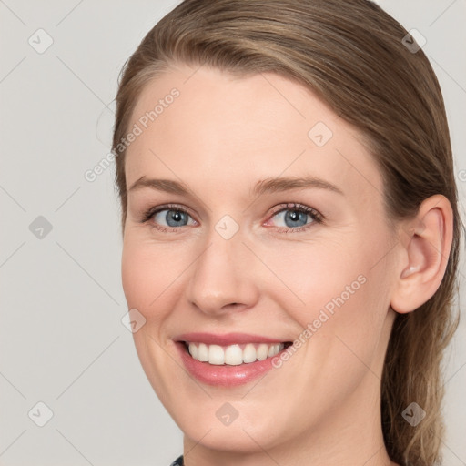 Joyful white young-adult female with medium  brown hair and blue eyes