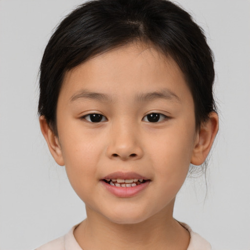 Joyful asian child female with medium  brown hair and brown eyes