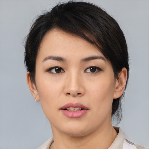 Joyful asian young-adult female with medium  brown hair and brown eyes