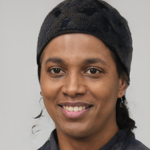 Joyful black young-adult female with medium  black hair and brown eyes