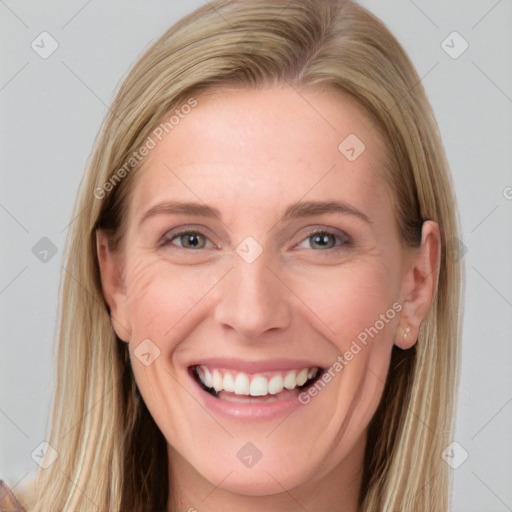 Joyful white young-adult female with long  brown hair and blue eyes