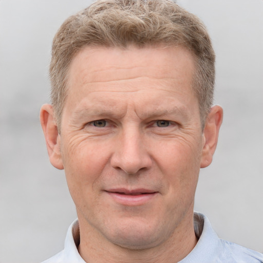 Joyful white middle-aged male with short  brown hair and brown eyes