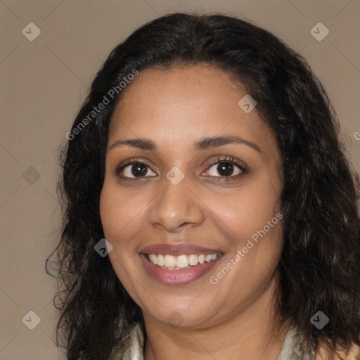 Joyful black young-adult female with long  brown hair and brown eyes