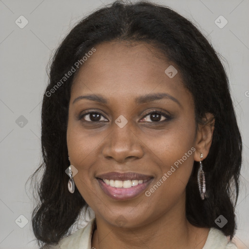 Joyful black young-adult female with long  brown hair and brown eyes