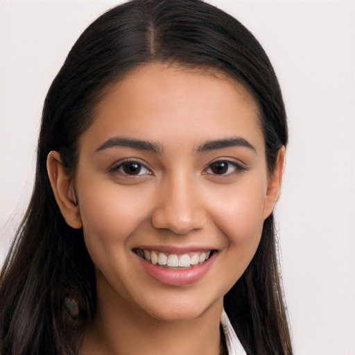 Joyful latino young-adult female with long  brown hair and brown eyes