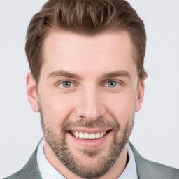 Joyful white adult male with short  brown hair and grey eyes