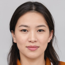 Joyful asian young-adult female with long  brown hair and brown eyes