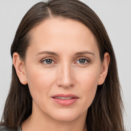 Joyful white young-adult female with long  brown hair and grey eyes