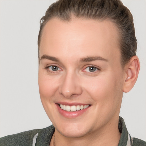 Joyful white young-adult female with short  brown hair and brown eyes