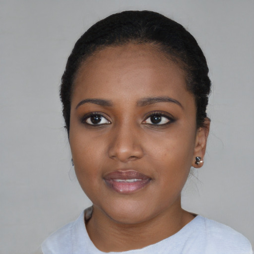 Joyful black young-adult female with short  black hair and brown eyes