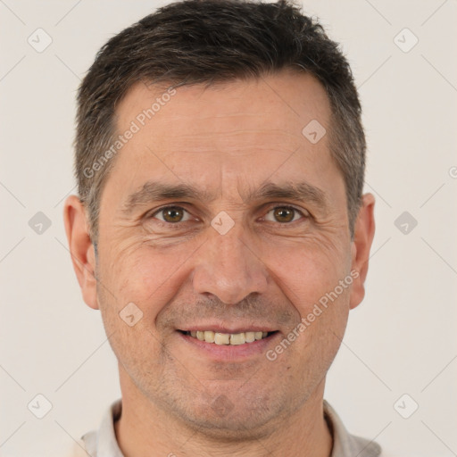 Joyful white adult male with short  brown hair and brown eyes