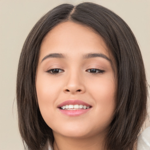 Joyful asian young-adult female with long  brown hair and brown eyes