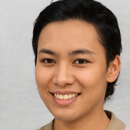 Joyful asian young-adult female with short  brown hair and brown eyes