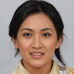 Joyful asian young-adult female with medium  brown hair and brown eyes