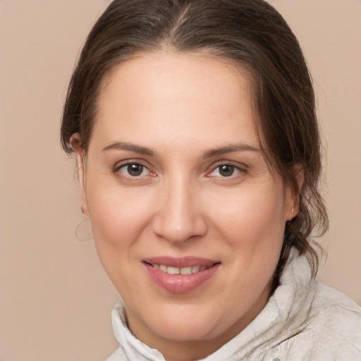 Joyful white adult female with medium  brown hair and brown eyes