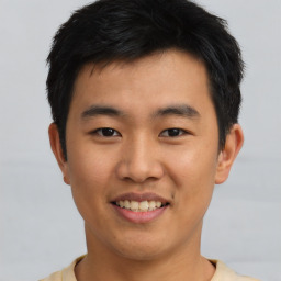 Joyful asian young-adult male with short  black hair and brown eyes