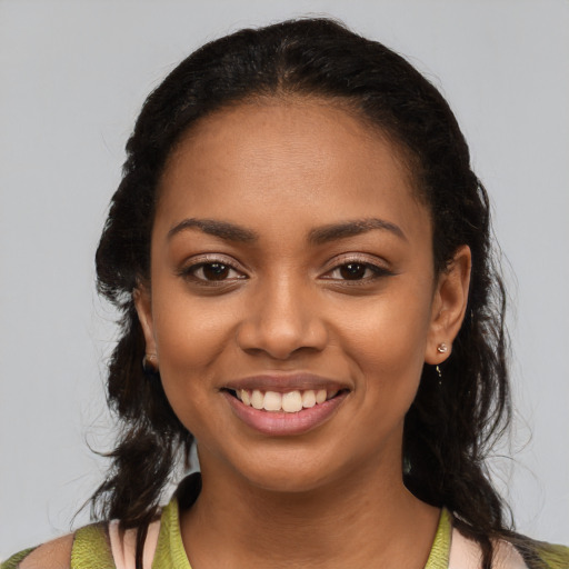 Joyful black young-adult female with medium  brown hair and brown eyes