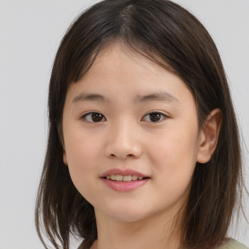 Joyful asian child female with medium  brown hair and brown eyes