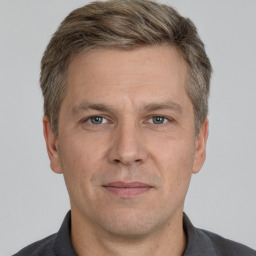 Joyful white adult male with short  brown hair and grey eyes