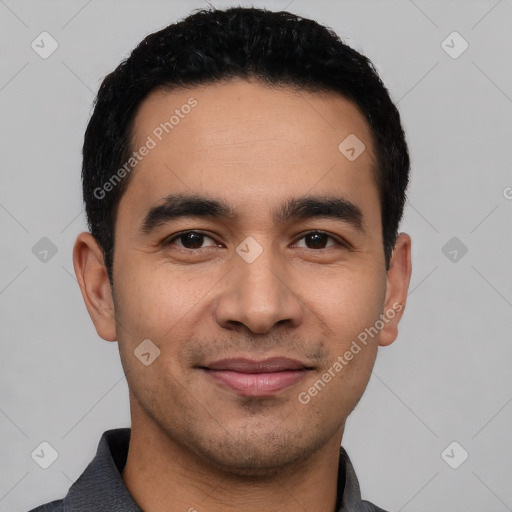 Joyful latino young-adult male with short  black hair and brown eyes