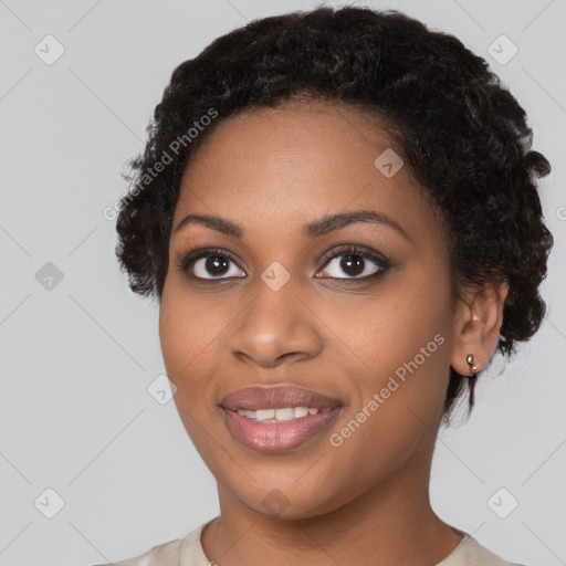 Joyful black young-adult female with short  black hair and brown eyes