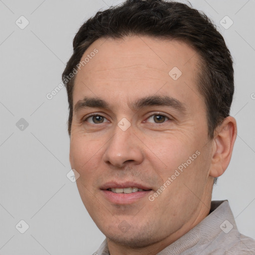 Joyful white adult male with short  brown hair and brown eyes