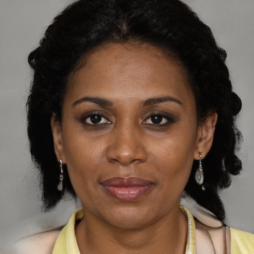 Joyful black adult female with medium  black hair and brown eyes