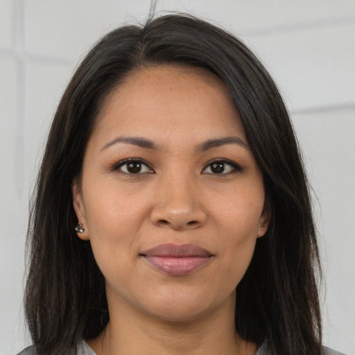 Joyful asian young-adult female with long  brown hair and brown eyes