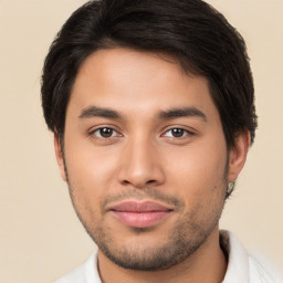 Joyful latino young-adult male with short  brown hair and brown eyes