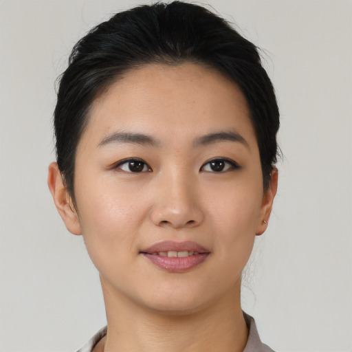 Joyful asian young-adult female with short  black hair and brown eyes