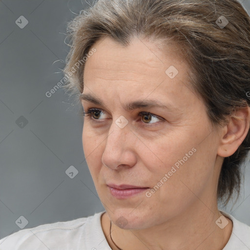 Joyful white adult female with medium  brown hair and brown eyes