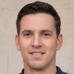 Joyful white young-adult male with short  brown hair and brown eyes