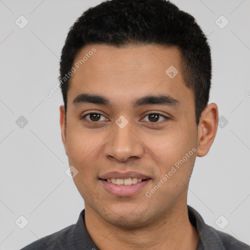 Joyful latino young-adult male with short  black hair and brown eyes