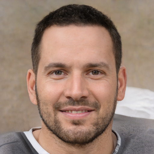 Joyful white young-adult male with short  brown hair and brown eyes